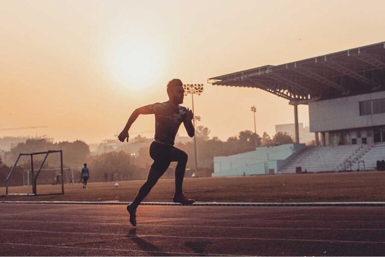 man running in track and field oval