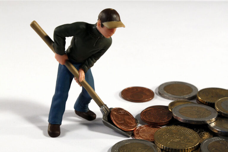 man shoveling coins